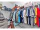 Walk-in closet with shelving and ample hanging space, filled with an assortment of clothing and storage boxes at 7536 Sw 77Th Ave, Ocala, FL 34481