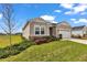 Charming single-story home with a two-car garage, lovely landscaping, and manicured lawn on a sunny day at 7536 Sw 77Th Ave, Ocala, FL 34481