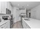 Bright kitchen featuring stainless steel appliances, a large island, white cabinets, and tiled floors at 7536 Sw 77Th Ave, Ocala, FL 34481