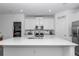 Bright kitchen with white cabinets, stainless appliances, and a spacious island at 7536 Sw 77Th Ave, Ocala, FL 34481