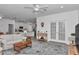 Open-concept living room with white walls, tile floors, and access to the kitchen at 7536 Sw 77Th Ave, Ocala, FL 34481