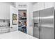 Pantry showcasing organized storage shelves and a stainless steel refrigerator at 7536 Sw 77Th Ave, Ocala, FL 34481