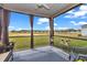Relaxing screened-in porch with comfortable seating and a view of the community's green space beyond the fence at 7536 Sw 77Th Ave, Ocala, FL 34481