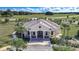 Stunning aerial view of a grand single-story home with lush landscaping and a circular driveway at 9210 Sw 60Th Court Rd, Ocala, FL 34476