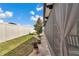 Well-manicured backyard with a privacy fence, a lush green lawn, and a glimpse of the screened-in patio at 9210 Sw 60Th Court Rd, Ocala, FL 34476