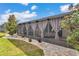 Beautiful backyard featuring a screened-in patio with curtains, lush landscaping, and a well-maintained lawn at 9210 Sw 60Th Court Rd, Ocala, FL 34476