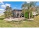Well-maintained backyard featuring a screened-in patio, lush green grass, and mature trees for added privacy at 9210 Sw 60Th Court Rd, Ocala, FL 34476