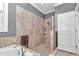Bathroom showcasing a soaking tub, walk-in shower, and elegant tile work at 9210 Sw 60Th Court Rd, Ocala, FL 34476