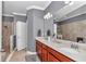 Bathroom featuring a double sink vanity, large mirror and a walk-in shower at 9210 Sw 60Th Court Rd, Ocala, FL 34476