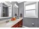 Bathroom features double sinks, granite countertop, and grey walls at 9210 Sw 60Th Court Rd, Ocala, FL 34476