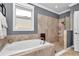 Bathroom showcasing a soaking tub, walk-in shower, and elegant tile work at 9210 Sw 60Th Court Rd, Ocala, FL 34476