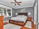 Cozy bedroom with a large window, gray walls, and hardwood floors at 9210 Sw 60Th Court Rd, Ocala, FL 34476