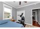 Neutral-toned bedroom with a bed and exercise machine beside a window and closet at 9210 Sw 60Th Court Rd, Ocala, FL 34476