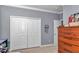 Bedroom featuring closet, dresser and door at 9210 Sw 60Th Court Rd, Ocala, FL 34476