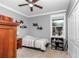 Comfortable bedroom showcasing a twin bed, ceiling fan, and storage at 9210 Sw 60Th Court Rd, Ocala, FL 34476