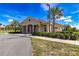 Charming community clubhouse surrounded by lush landscaping, sidewalks, and palm trees at 9210 Sw 60Th Court Rd, Ocala, FL 34476