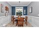 Eat-in kitchen dining nook with modern light fixture and wainscotting at 9210 Sw 60Th Court Rd, Ocala, FL 34476