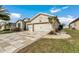 Charming single-story home with lush landscaping, a paver driveway, and a two-car garage at 9210 Sw 60Th Court Rd, Ocala, FL 34476