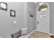 Inviting foyer with tiled floor, arched transom window over door, and welcome decor at 9210 Sw 60Th Court Rd, Ocala, FL 34476