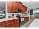 Modern kitchen with white countertops, stainless steel appliances, and lots of wood cabinetry at 9210 Sw 60Th Court Rd, Ocala, FL 34476