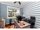 Bright home office featuring hardwood floors, a ceiling fan, and an expansive desk area at 9210 Sw 60Th Court Rd, Ocala, FL 34476