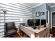 Comfortable home office with hardwood floors, blue accent wall, and ample desk space at 9210 Sw 60Th Court Rd, Ocala, FL 34476