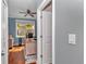 Home office with light blue walls, wood floors, ceiling fan, and bright natural light at 9210 Sw 60Th Court Rd, Ocala, FL 34476