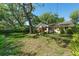 Picturesque backyard with expansive lawn, mature trees, and established landscaping at 926 Mayfair Cir, Orlando, FL 32803
