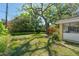 Grassy backyard with mature trees providing ample shade and lush landscaping at 926 Mayfair Cir, Orlando, FL 32803