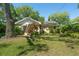 Spacious backyard featuring a well-maintained lawn, mature trees, and lush landscaping at 926 Mayfair Cir, Orlando, FL 32803