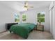 Comfortable bedroom with three bright windows, ceiling fan, and neutral color palette at 926 Mayfair Cir, Orlando, FL 32803