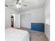 Bright bedroom with a ceiling fan, blue dresser, neutral carpet, and white walls at 926 Mayfair Cir, Orlando, FL 32803
