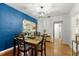 Charming dining room featuring hardwood floors, a wood table with chairs, and a bright blue accent wall at 926 Mayfair Cir, Orlando, FL 32803