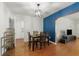 Bright dining room featuring hardwood floors, modern lighting fixture, and inviting blue accent wall at 926 Mayfair Cir, Orlando, FL 32803