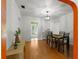 Well-lit dining room featuring hardwood floors, a modern light fixture, and access to the living room at 926 Mayfair Cir, Orlando, FL 32803