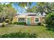 Charming single-story home featuring a mix of brick and siding, a well-manicured lawn and a teal front door at 926 Mayfair Cir, Orlando, FL 32803