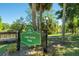 Signage for Lake Como Park in Orlando, surrounded by greenery, trees, and a wooden bridge in the background at 926 Mayfair Cir, Orlando, FL 32803