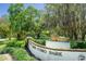 Lake Como Park entrance sign with lion statue, lush greenery, and glimpses of the serene lake at 926 Mayfair Cir, Orlando, FL 32803