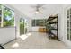 Sunroom with tile flooring, multiple windows, and storage shelves with nature views at 926 Mayfair Cir, Orlando, FL 32803