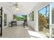 Bright sunroom featuring tile flooring, multiple windows, grill, and ceiling fan at 926 Mayfair Cir, Orlando, FL 32803