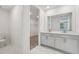 Modern bathroom featuring double sinks, a walk-in closet, and marble-look floors at 2352 Citrus Bloom Dr, Bartow, FL 33830