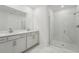 Elegant bathroom featuring dual sinks, stone counters, and a glass-enclosed shower with marble tile at 2352 Citrus Bloom Dr, Bartow, FL 33830