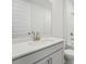 Bright bathroom with a white vanity, quartz counters, brushed nickel hardware, and white tile at 2352 Citrus Bloom Dr, Bartow, FL 33830
