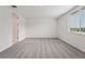 Empty bedroom featuring neutral carpet, bright walls, a large window, and a walk-in closet at 2352 Citrus Bloom Dr, Bartow, FL 33830
