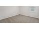 Bright bedroom features a window for natural light and neutral carpet floors at 2352 Citrus Bloom Dr, Bartow, FL 33830