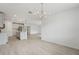 Open-concept dining and kitchen area with wood-look floors and stylish lighting fixtures at 2352 Citrus Bloom Dr, Bartow, FL 33830