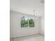 Bright dining area featuring a modern chandelier and a large window with scenic views at 2352 Citrus Bloom Dr, Bartow, FL 33830
