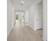 Bright hallway with wood-look flooring leading to the backyard and bedrooms at 2352 Citrus Bloom Dr, Bartow, FL 33830