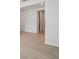 Bright hallway showing an open floorplan with wood-look floors and white walls at 2352 Citrus Bloom Dr, Bartow, FL 33830