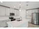 Modern kitchen with stainless steel appliances, white cabinetry, and a spacious center island at 2352 Citrus Bloom Dr, Bartow, FL 33830